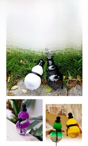 Detailed close-up of colorful gourd-shaped water bottles with traditional decorative ropes