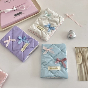 Quilted passport holder with bow details and Sozakka label in pastel colors