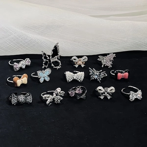 Collection of 14 assorted butterfly and bow open rings with zircons and enamel