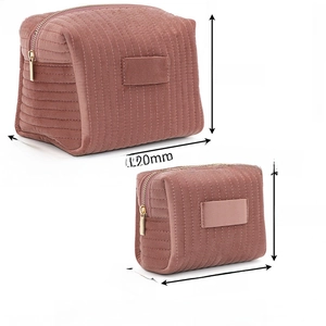Pink velvet cosmetic bag duo with vertical quilting detail and metal zipper closure