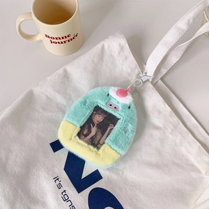 Detail of plush dessert card holder charms hanging on a white canvas bag with hook design