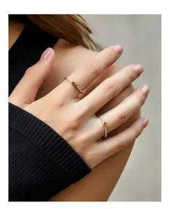 Detail of stacked s925 silver rings with infinity symbol and heart shaped icons