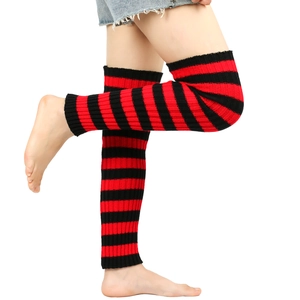Close-up of red and black striped knitted leg warmers with soft wool texture for women