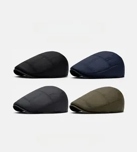 Close-up of winter newsboy caps in black, blue, gray, and green with fine textured fabric