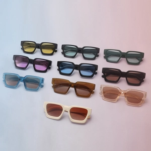 Collection of modern chunky square sunglasses in various colors on a blue and pink background
