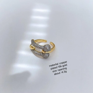 Elegant two-tone 18K gold plated crossover ring with sparkling crystals on white base