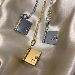 Locket book necklaces in silver, gold, and rose gold with heart cutout on silk
