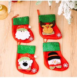 Detailed view of four mini Christmas stockings with sequins and cartoon appliques