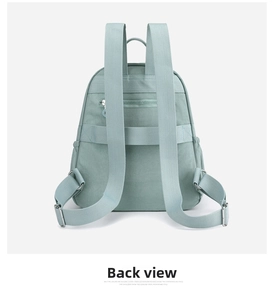 Detailed back view of light green nylon backpack with anti-theft zipper pocket and straps