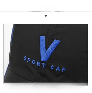 Detail of blue V embroidery and triple-layer peak structure on black baseball cap