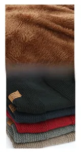 Detail of warm brown fleece lining and knitted texture with F&S leather patch