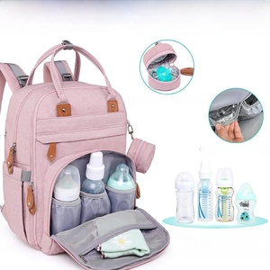 Detail of insulated pockets and detachable pacifier pouch on pink diaper backpack