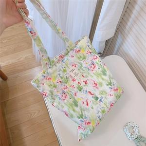 Detail of floral canvas tote bag with watercolor prints and comfortable wide shoulder strap