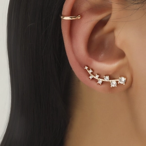 Close-up of a gold ear crawler and cuff set with sparkling white zircon crystals