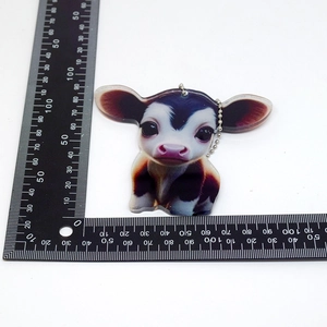 Detailed size view of cartoon cow acrylic pendant showing 75mm width and 65mm height