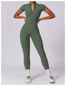 Detail of olive green short sleeve yoga jumpsuit with front zipper and stand collar