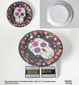 Close-up of Day of the Dead party plates with sugar skull and colorful floral patterns