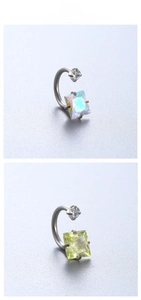 Detail of horseshoe ear piercing with square zirconia in iridescent and yellow hues