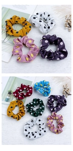 Close-up of colorful polka dot satin scrunchies with smooth texture and glossy finish