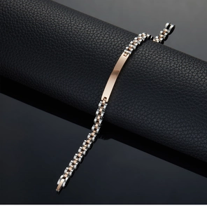 Macro detail of two-tone stainless steel link bracelet with polished silver and rose gold finish