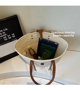 Top view of spacious woven tote bag showing interior capacity with tablets and umbrella