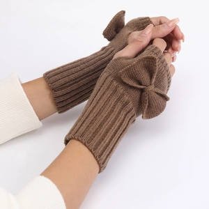 Detail view of brown knitted fingerless gloves with bow decoration for women