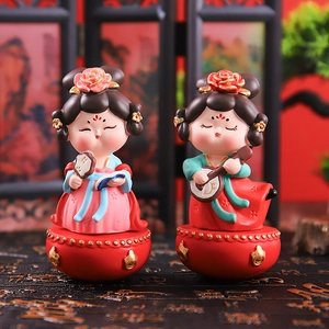 Detail of Tang Dynasty style resin figurines with colorful attire and golden accents