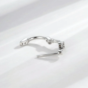 Minimalist silver note-shaped ear cuff with sparkling clear gemstones in a polished finish