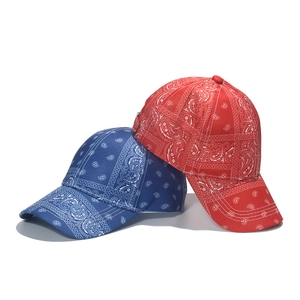 Close-up of red and blue baseball caps with classic paisley bandana print details