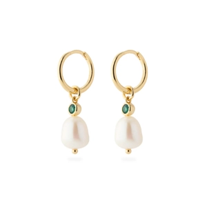 Detail of gold earrings featuring green gemstones and hanging white baroque pearls