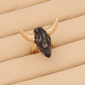 Vintage bohemian ox skull ring in gold and black with retro gothic punk style detail