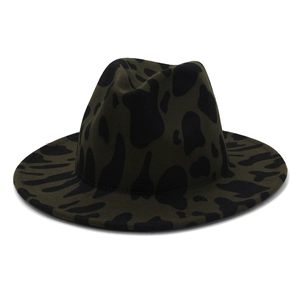 Detail view of deep green and black cow print fedora with wide brim and felt texture