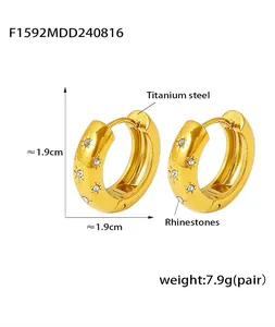 Detailed view of gold titanium hoop earrings with micro-inlaid rhinestone star pattern