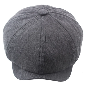 Close-up of a dark grey washed cotton newsboy cap with eight-panel crown and top button