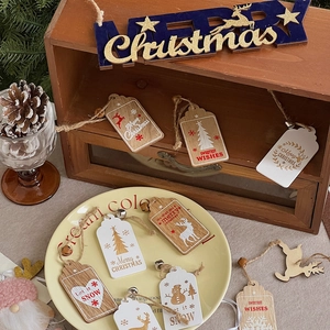 Detail of wooden Christmas ornaments with twine and bells on a warm rustic shelf
