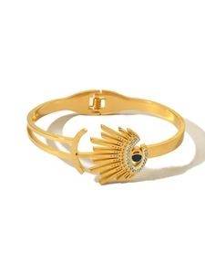 Detailed macro view of 18K gold plated evil eye spring bracelet with blue crystal