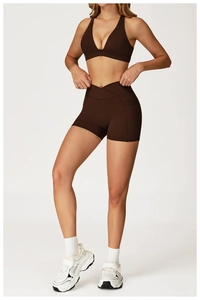 Detail of high-waist yoga shorts with cross-waist design and practical side pockets