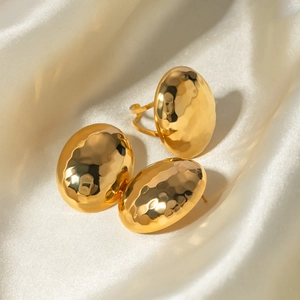 Detail of 18k gold plated stainless steel jewelry set with handmade hammered texture