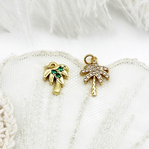 18K gold plated palm tree pendants with micro-pave crystals on white lace background