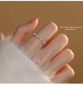 Detailed view of S925 sterling silver hollow heart ring with zircon on a finger