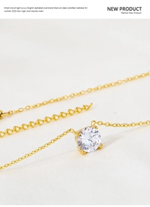 Detailed view of single round zircon pendant on gold-plated titanium steel chain