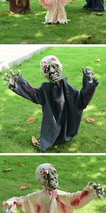 Detail of Halloween zombie ground stakes featuring bloodied robes and realistic facial wounds