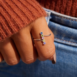 Detail of slim silver ring with five colorful vertically aligned round gemstones