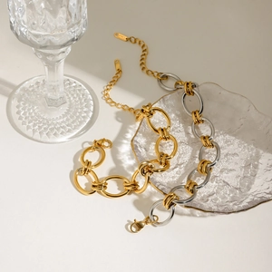 Detail of two-tone gold and silver stainless steel chunky chain bracelet with lobster clasp