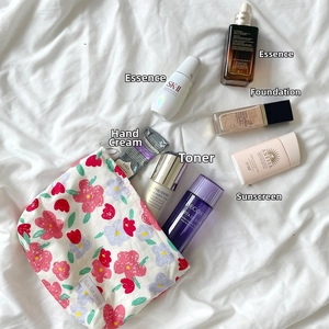 Flat lay macro of floral cosmetic bag with zipper and colorful flower patterns on top