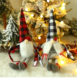 Detail of Christmas gnomes in red and black plaid hats on snowy background decor