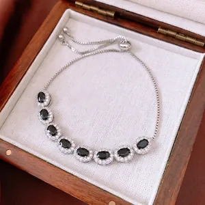 Adjustable silver bracelet with oval black stones and zircon pavé in a gift box