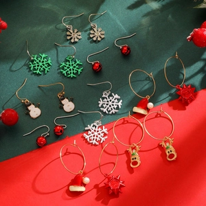 Detailed close-up of festive Christmas stud earring set featuring reindeer and snowman icons