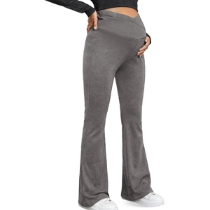 Detail of high-waist maternity yoga pants in charcoal grey featuring flared legs