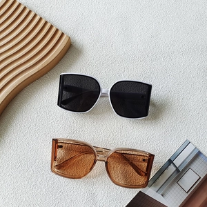 Fashionable oversized square sunglasses in two-tone black and white and amber colors